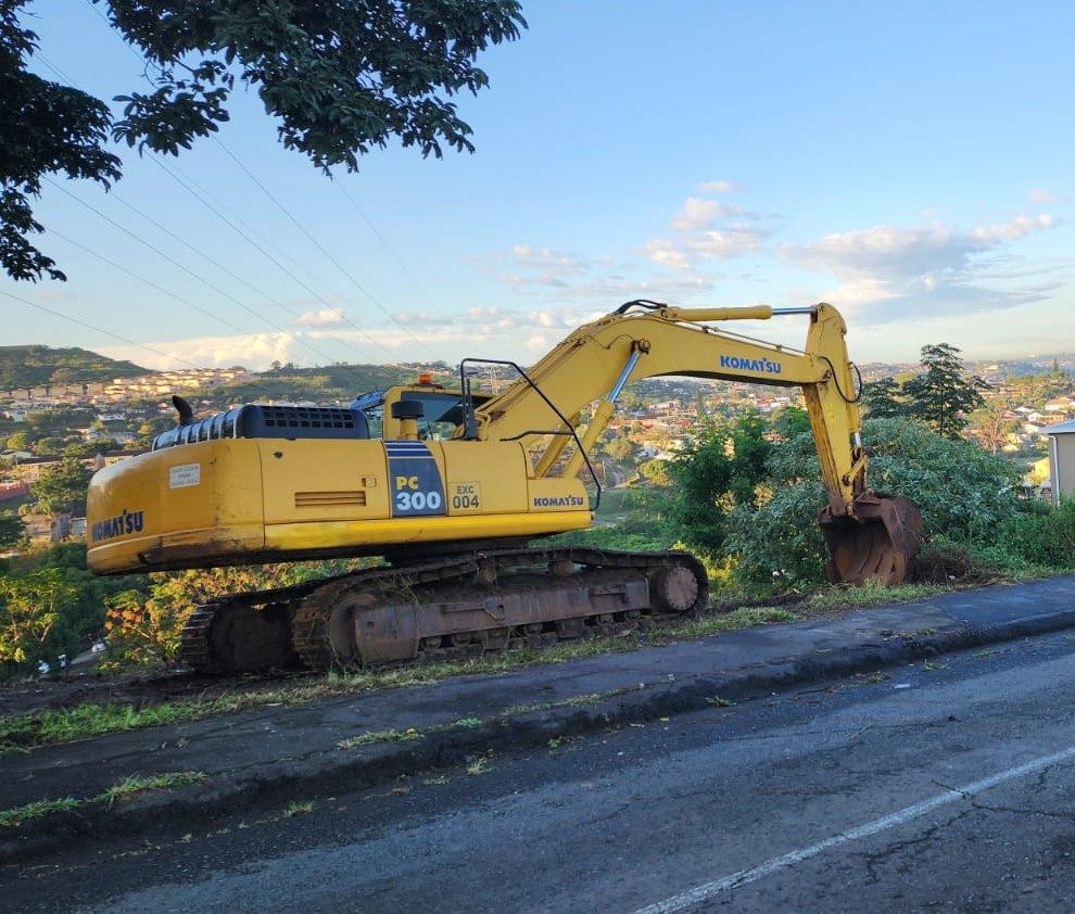 Komatsu D65EX bulldozer on site at sunset