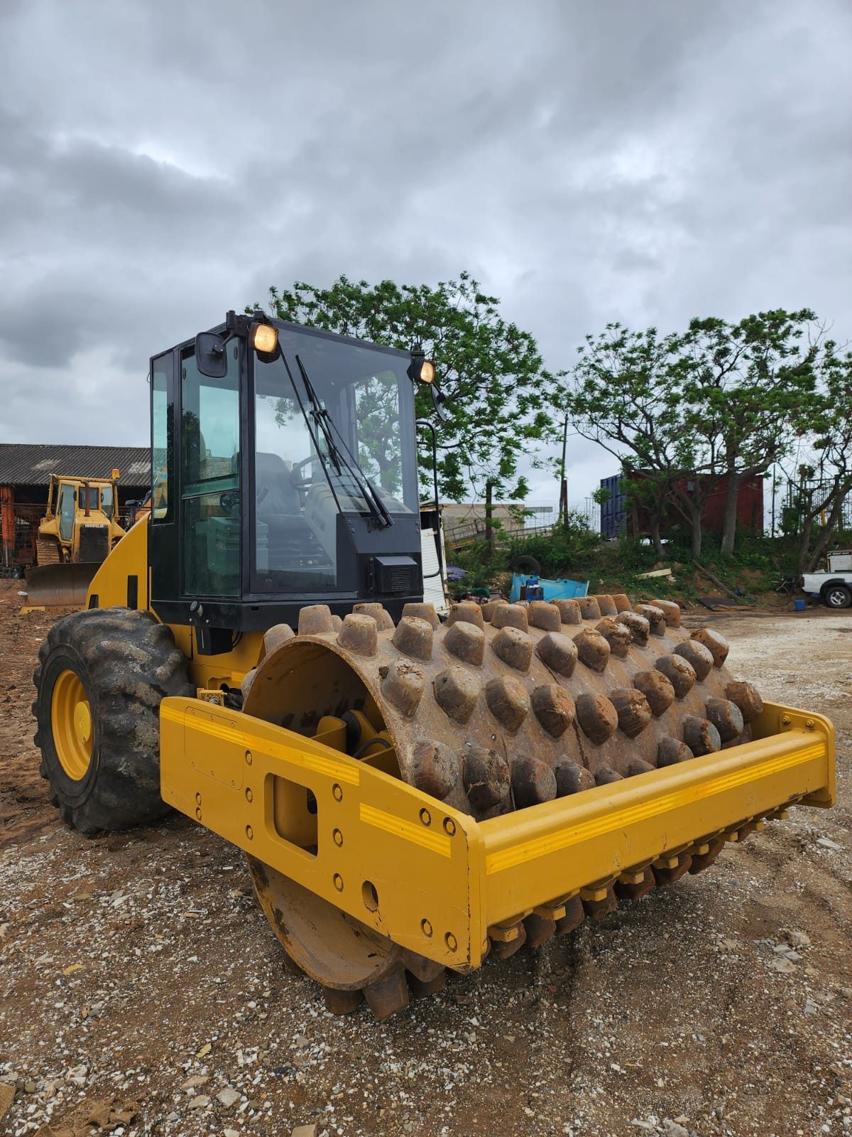 Yellow padfoot roller in the Dozerman yard